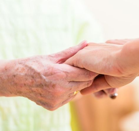 Two people holding hands