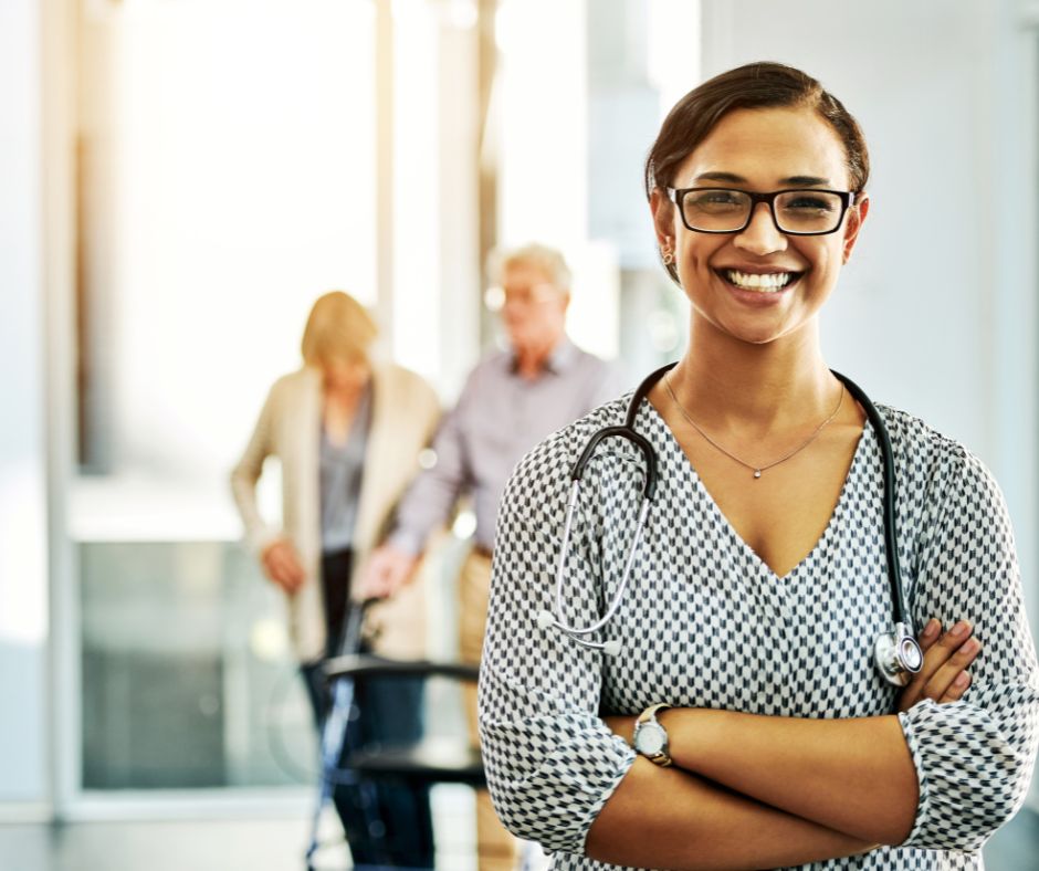 female medical professional with senior couple entering the building behind her the male is using a walker