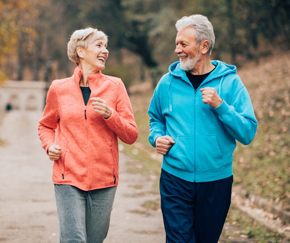 Senior couple running outside