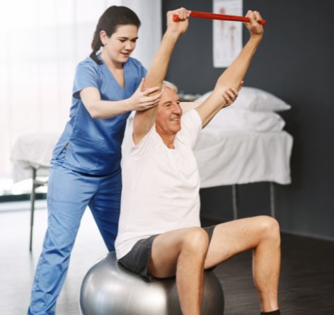 Trainer holding man with a stretch band