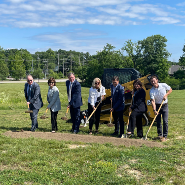 group of people digging into the ground