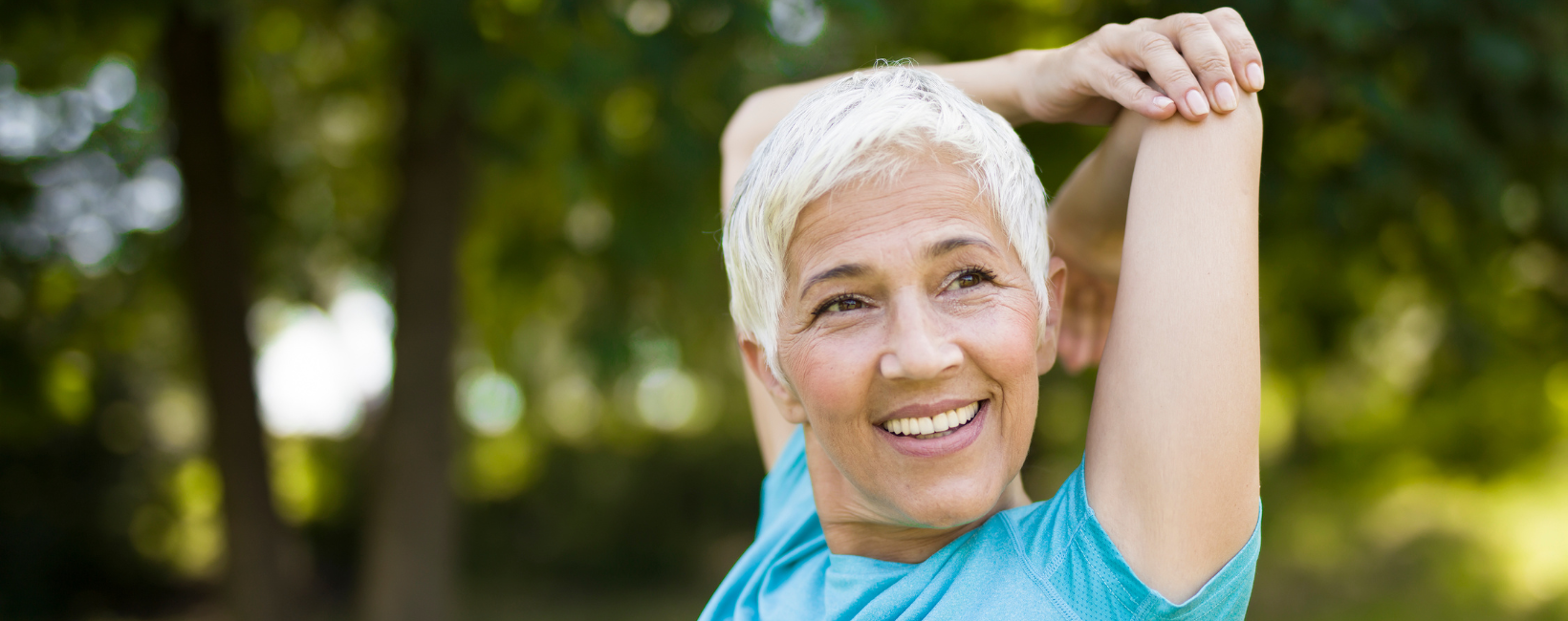 Older woman stretching outside and staying active