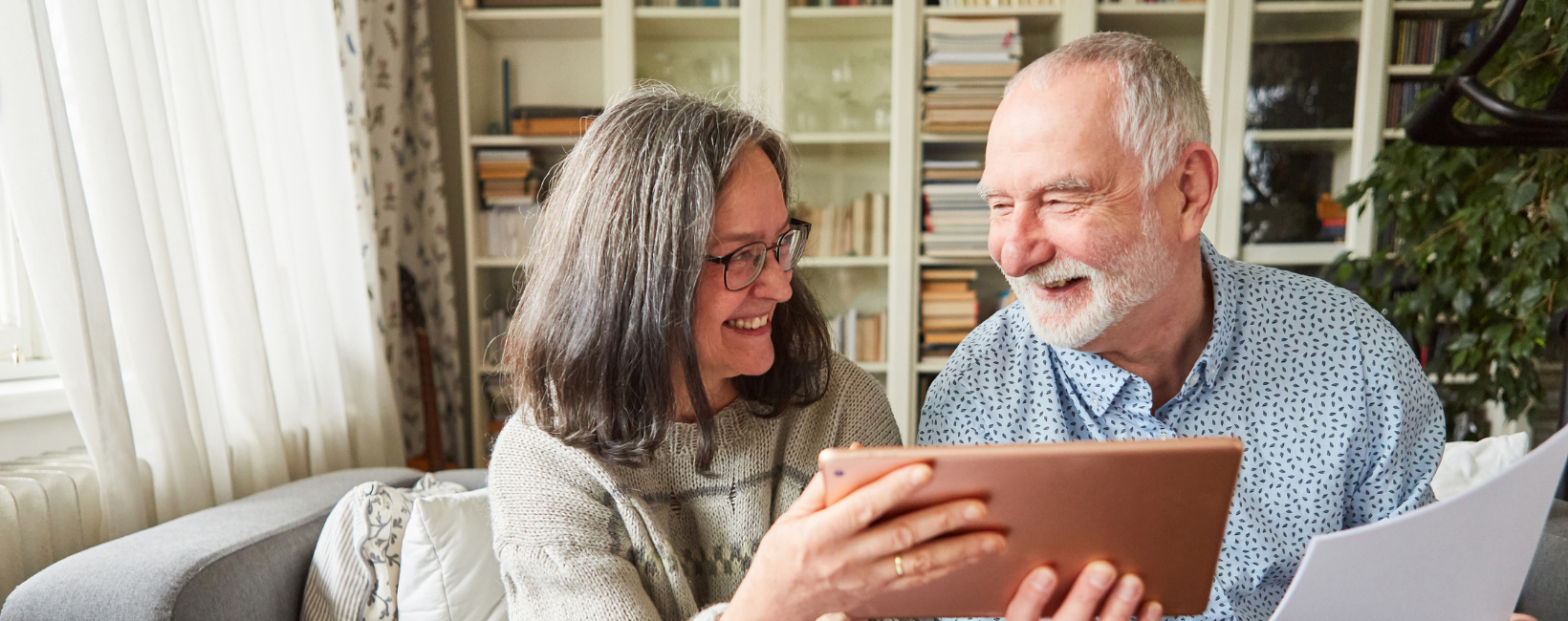 Older couple smiling and getting on a senior living waitlist