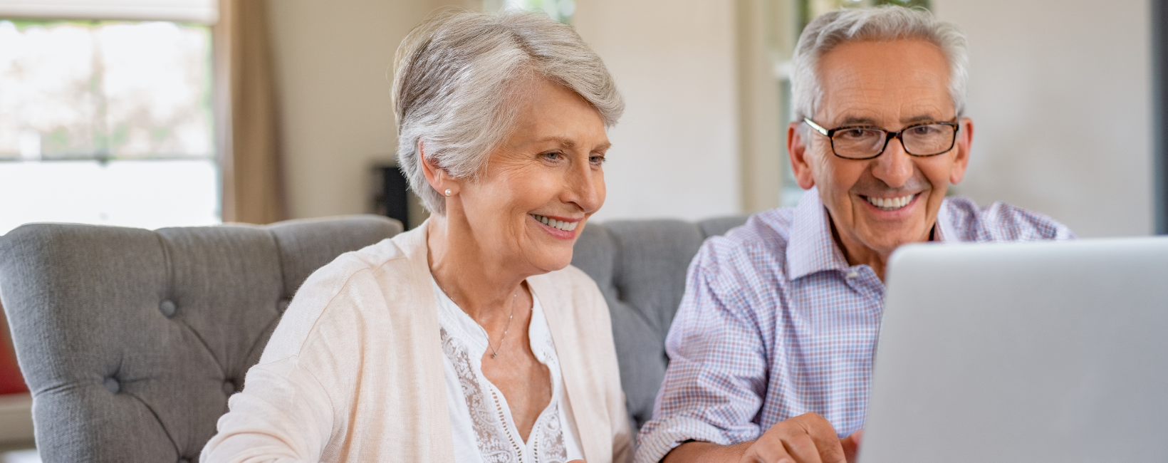 Senior couple on computer for virtual senior living community tour