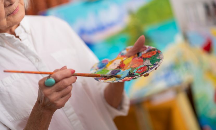an older woman painting