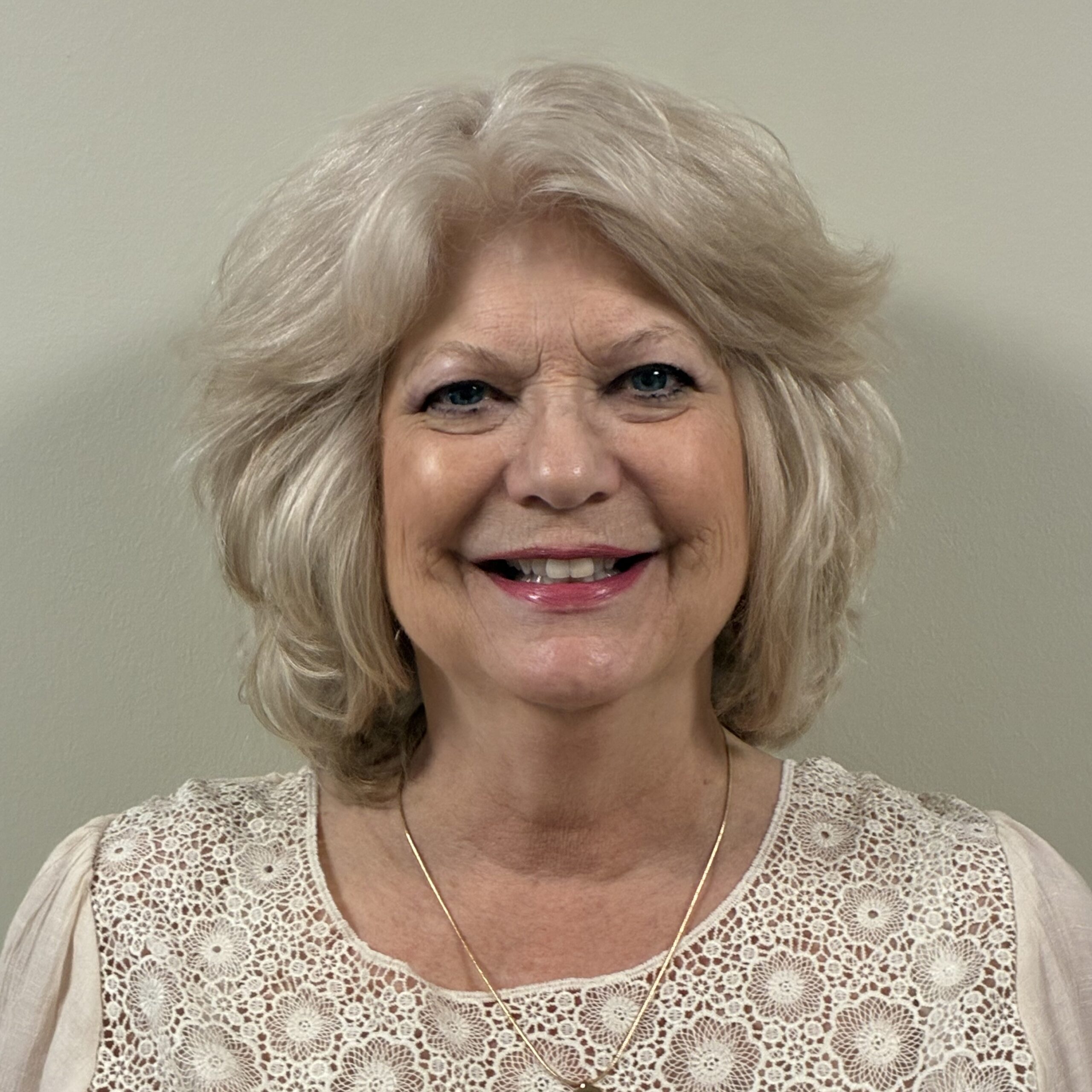 Headshot of Laura Chernauskas, Sales Specialist at Concord Reserve, smiling and wearing a light-colored lace top against a neutral background.