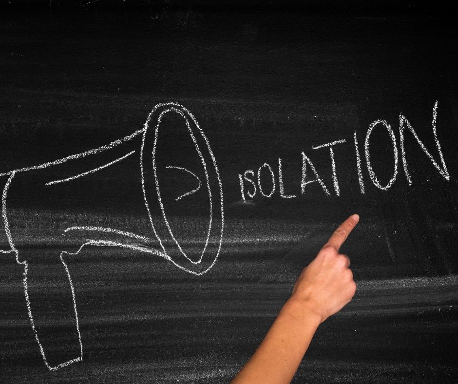 Megaphone drawn on chalkboard with the word _isolation_ coming out