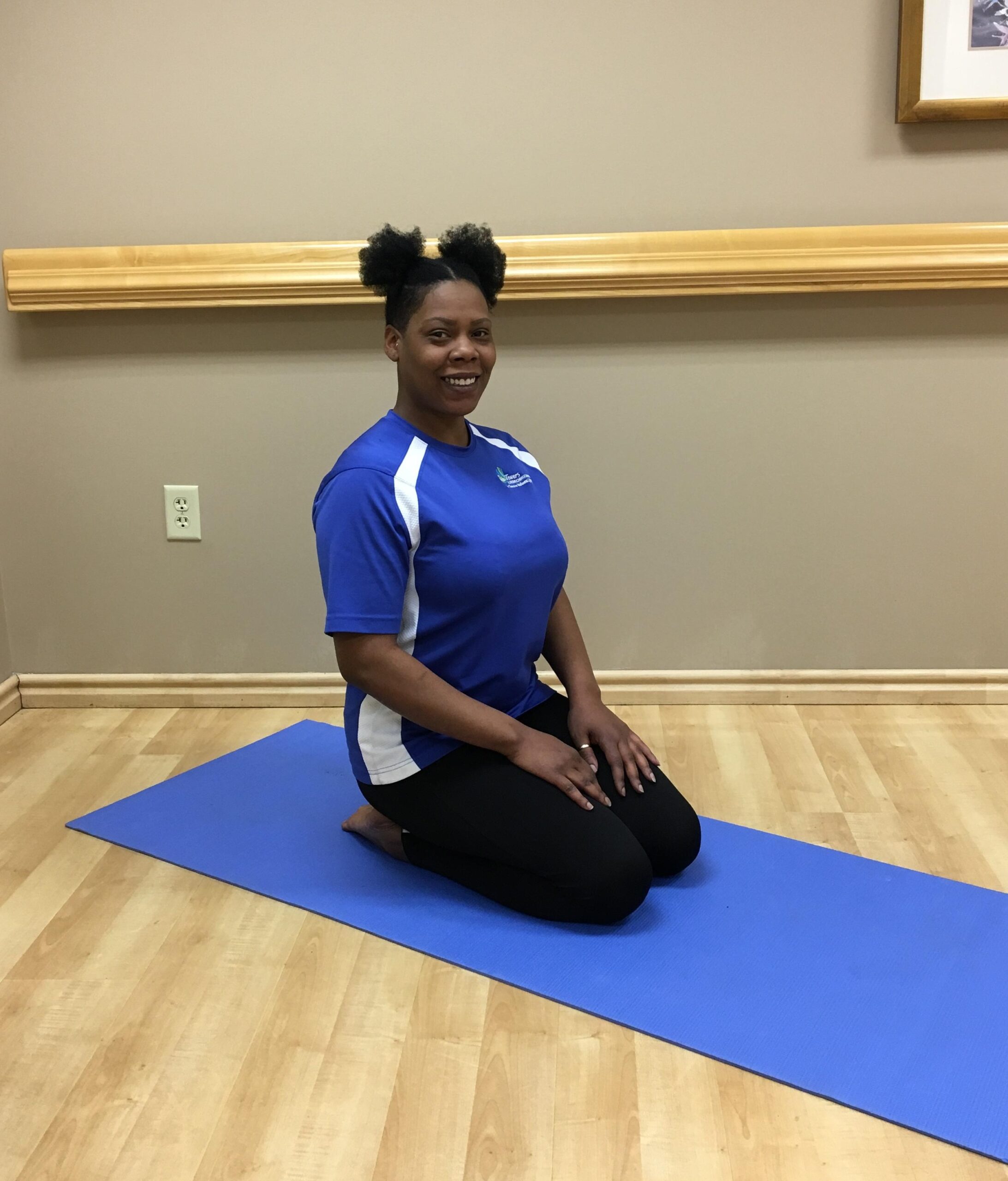 woman sitting on her legs on yoga mat