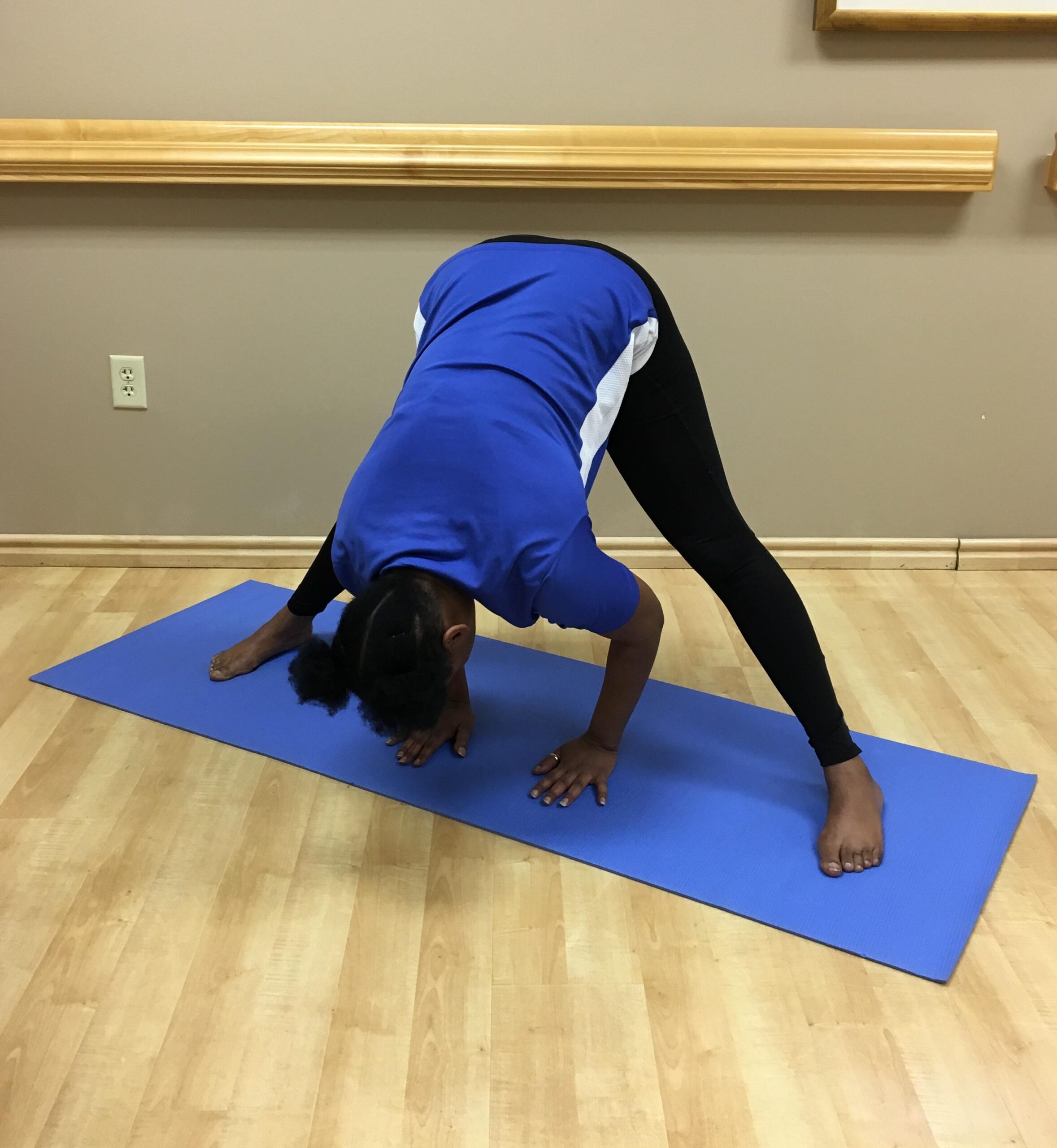 woman standing with legs out and touching the floor