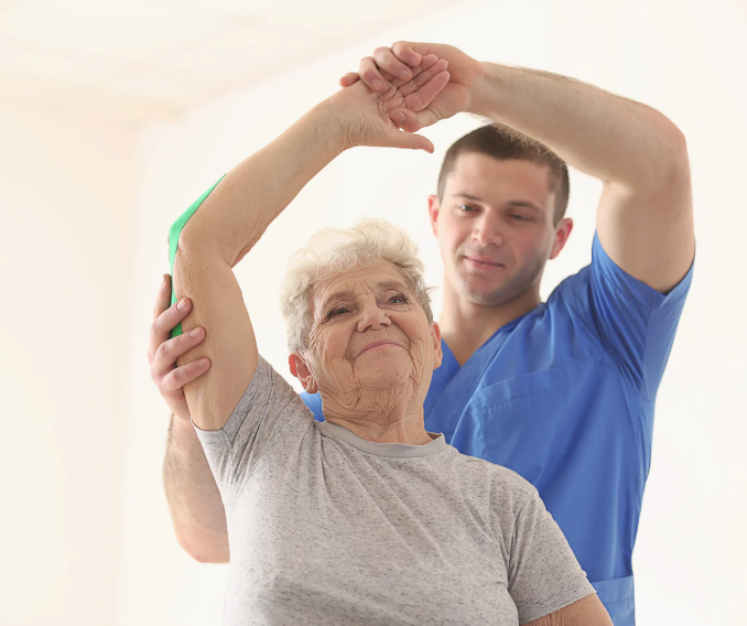 Physical therapy nurse helping older woman stretch