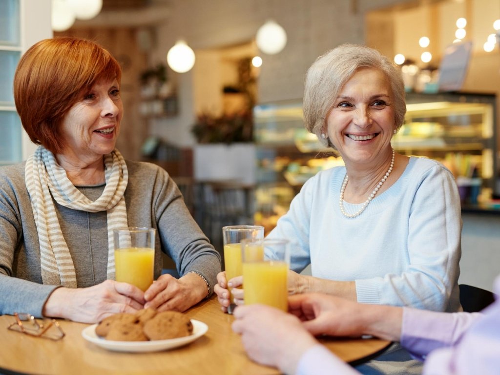 women drinking orange juice