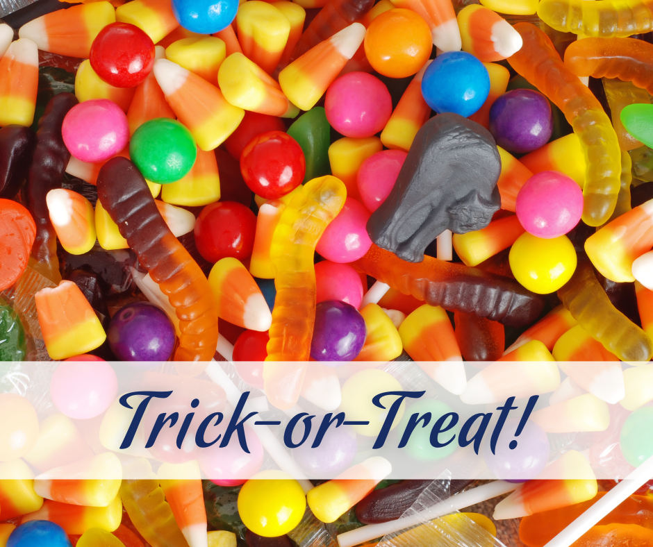 Assorted Halloween candy with a banner that says 