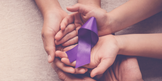 Hands holding a purple ribbon for Alzheimer's