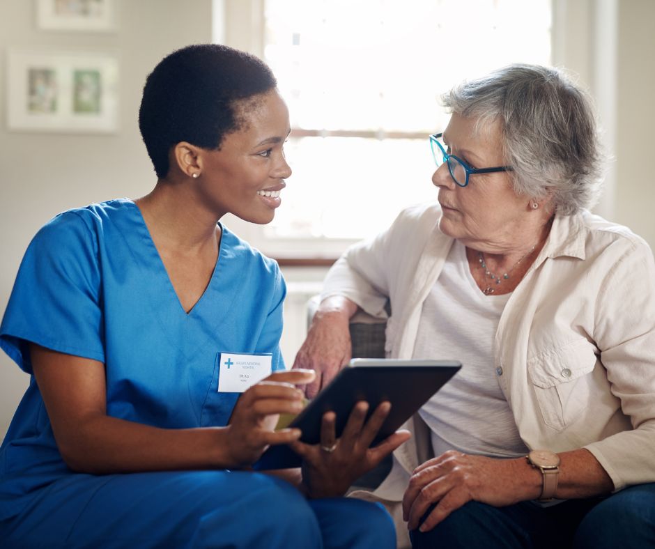nurse and senior talking while looking at tablet in assisted living at Concord Reserve