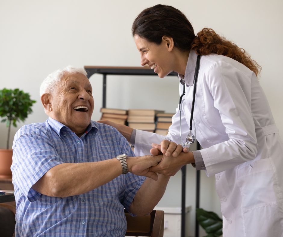 medical professional laughing with senior patient