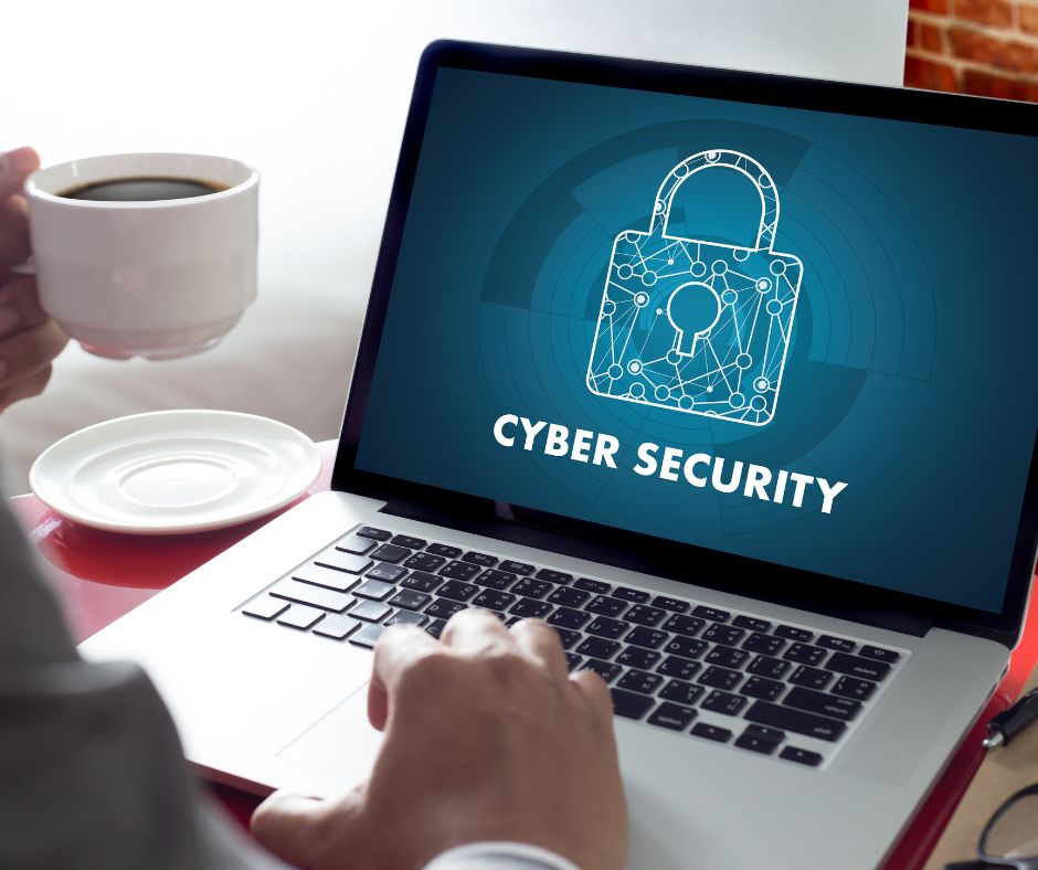 person drinking coffee looking at laptop