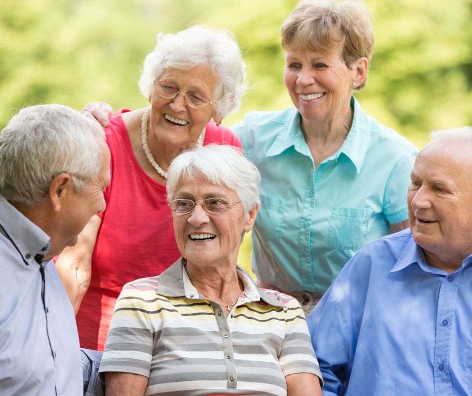 adult seniors outside chatting and smiling