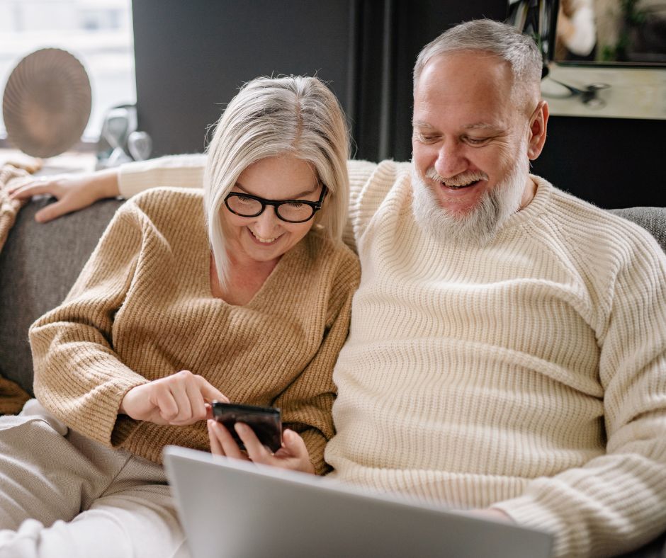 two adults on a computer together