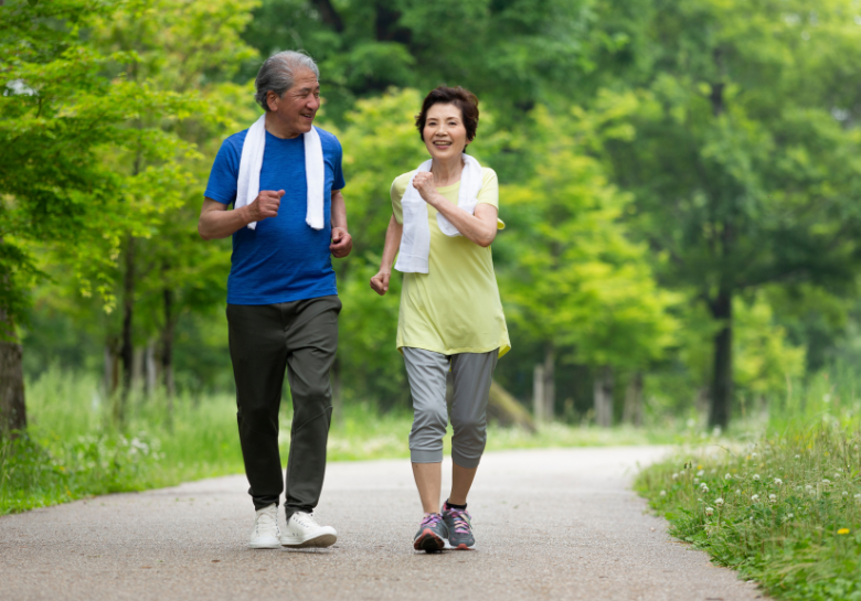 Older adult couple walking on path