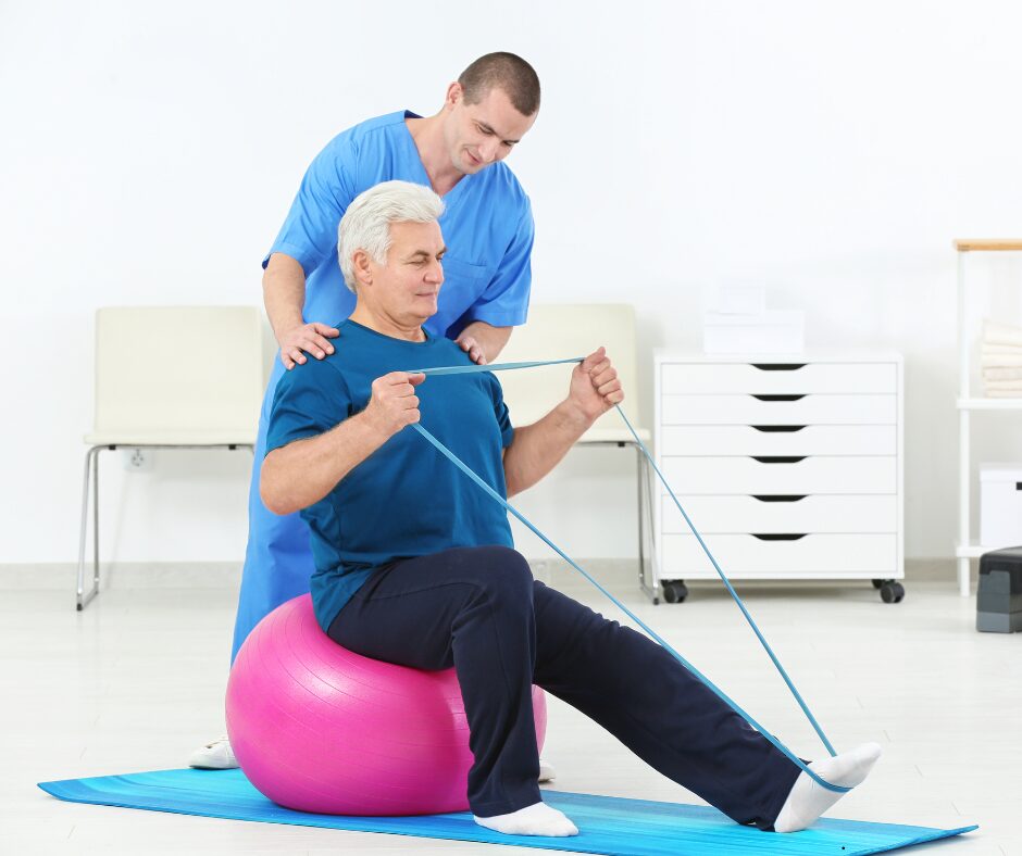 Physical Therapist with senior man on with a band stretching out his leg