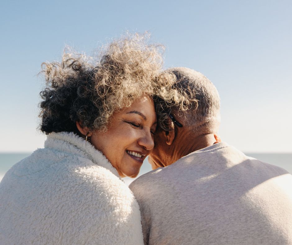 two adults leaning on each other
