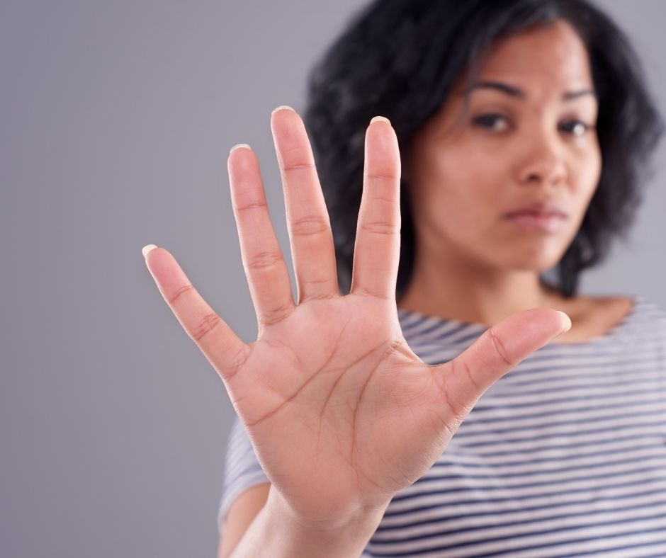 Woman holding up her hand indicating stop