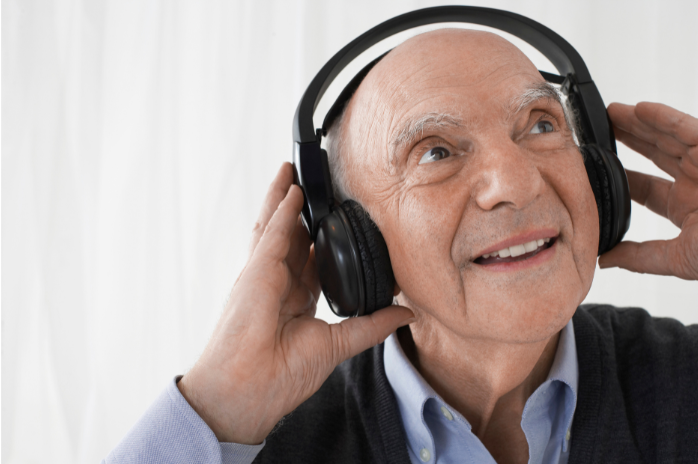 senior man with headphones on smiling