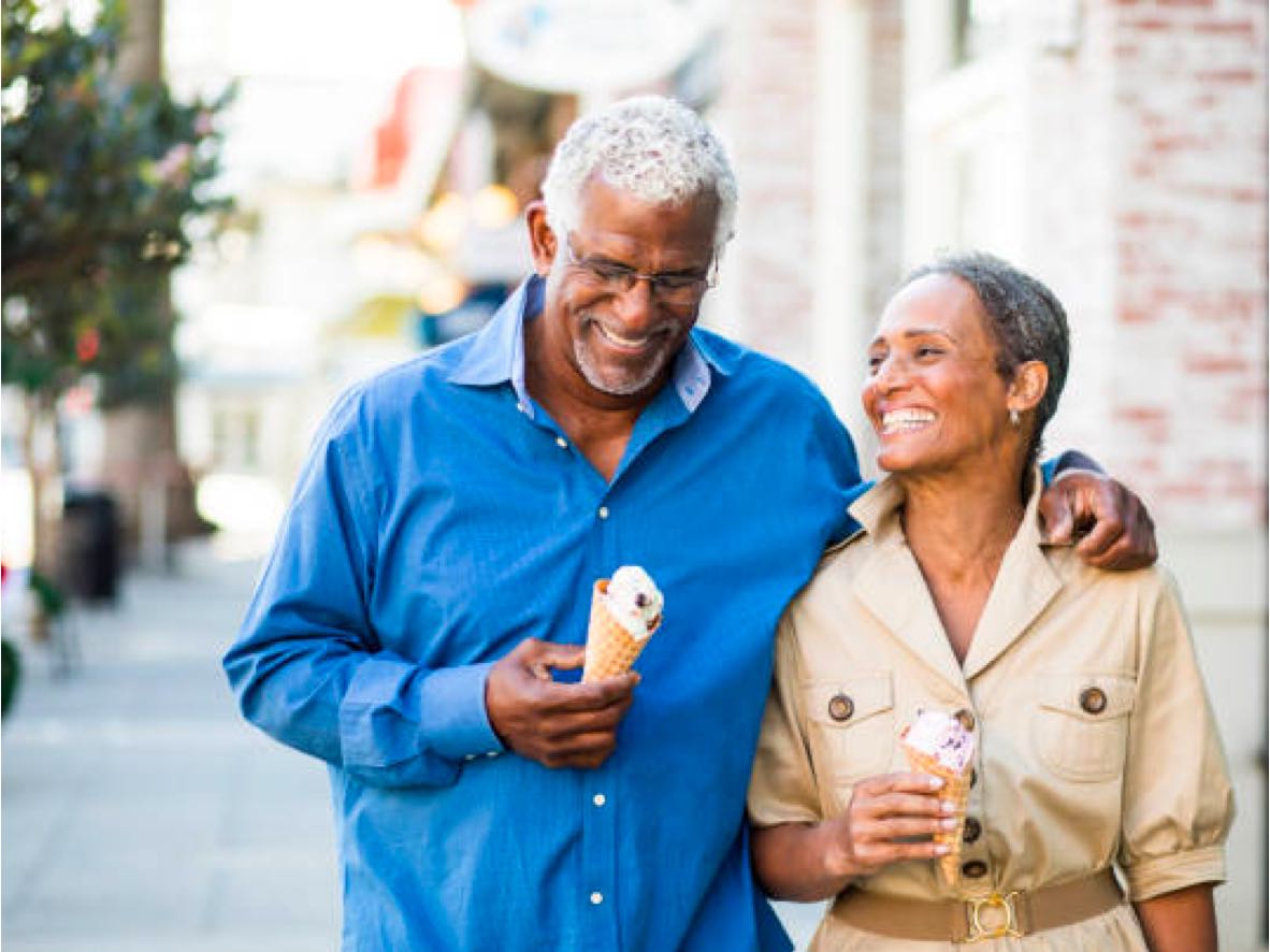 senior couple walking down the street with ice cream cones