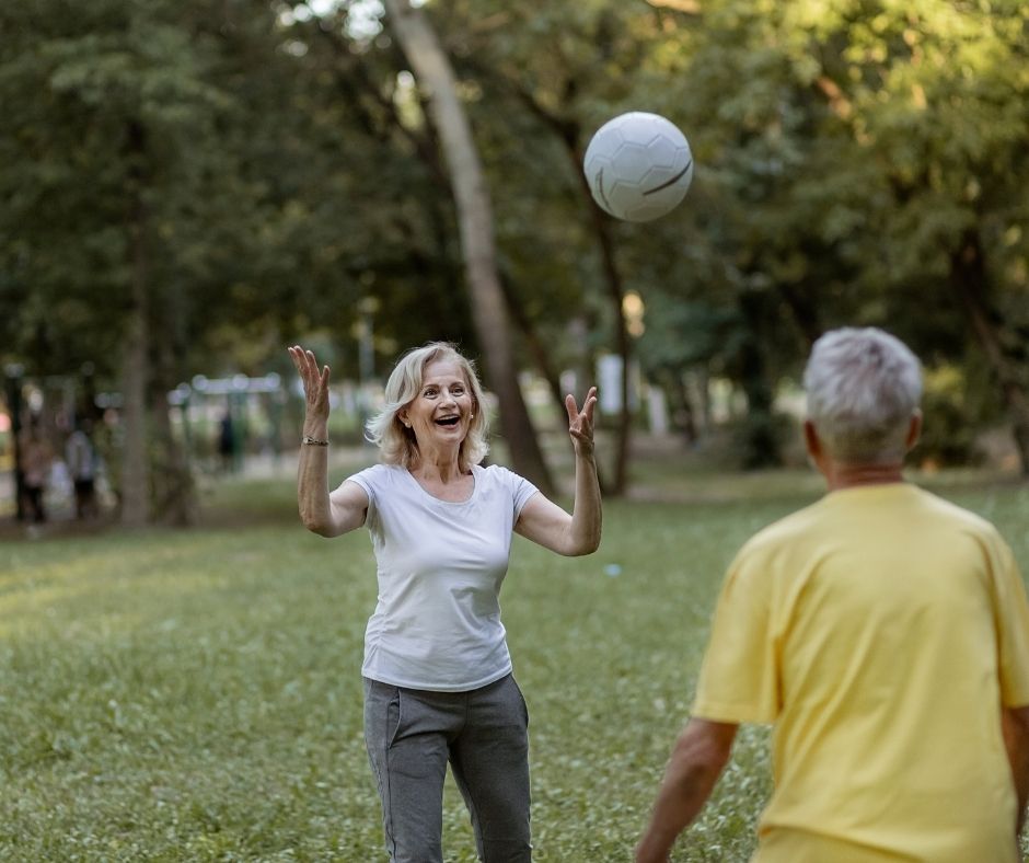 seniors outside tossing volleyball