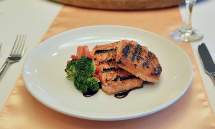 upscale grilled salmon and vegetable medley on formal dining plate