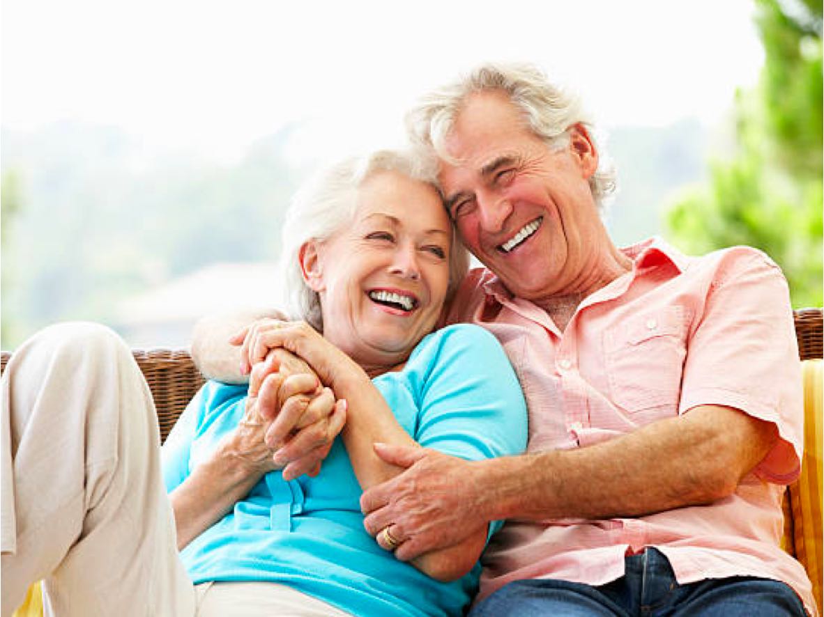 happy senior couple on outdoor furniture independent living homes