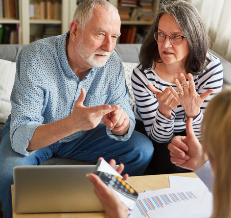 Middle-aged couple meeting with a financial advisor to plan for family members senior care