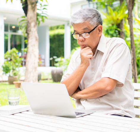 middle-aged Asian man researching assisted living care options