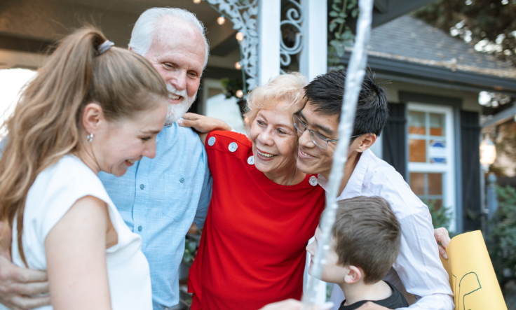 Group of people of varying ages embracing