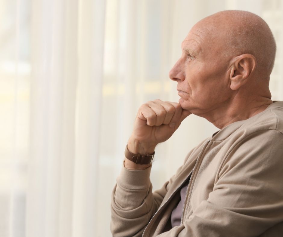 lone man gazing out a window