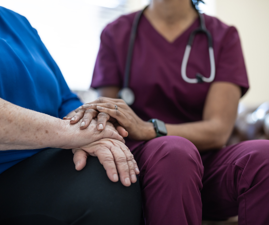 Nurse holding hands with patient