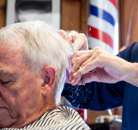 Senior man getting a haircut