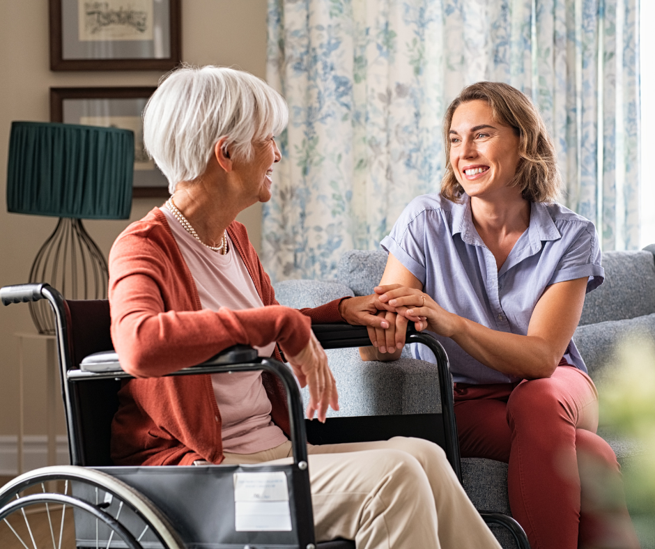 Senior woman in a wheelchair talking with her adult daughter about assisted living