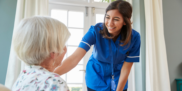 Volunteer reassuring senior woman