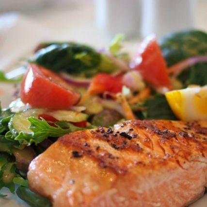 Salmon and salad on dinner plate