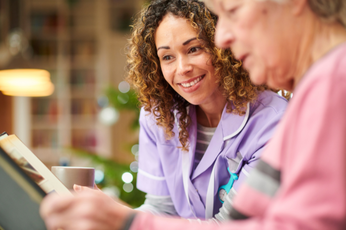 memory support in Reynoldsburg, nurse looking at photo album with senior woman