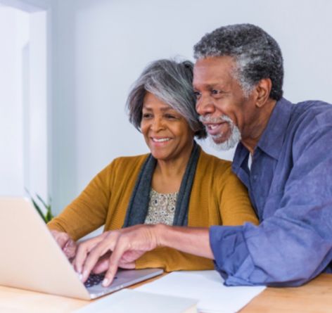 Middle aged African American couple looking at laptop together