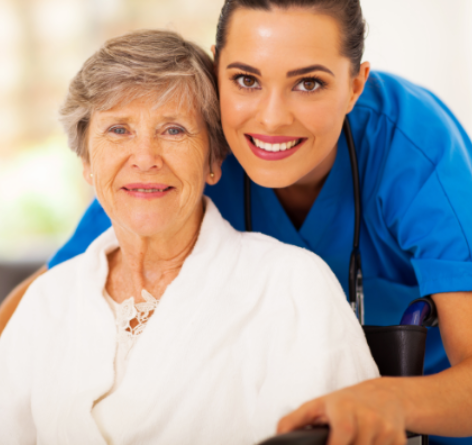 senior woman with nurse, both are smiling in rehabilitation