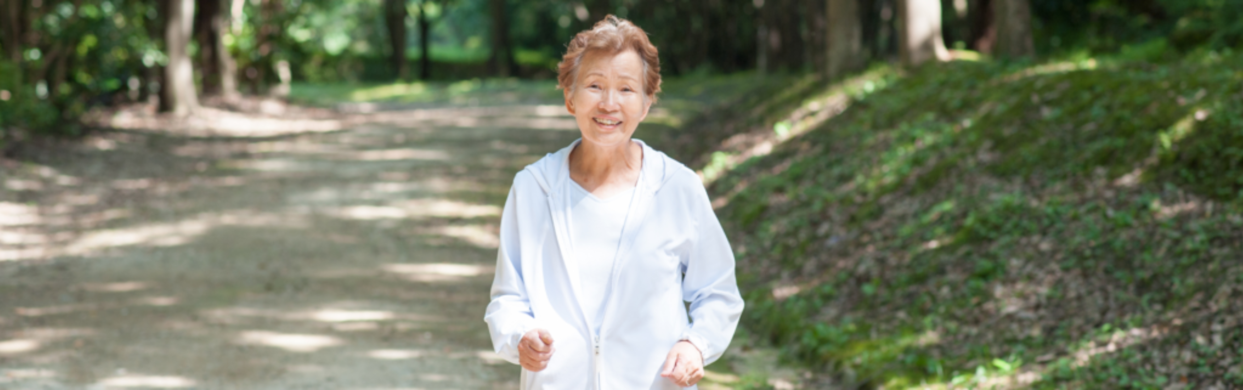 Senior Asian woman on a walking trail outside independent apartment home