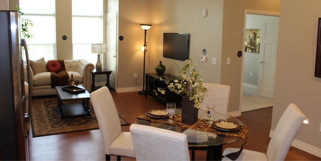 Interior of Wesley Woods one-bedroom senior apartment showcasing dining table and living room