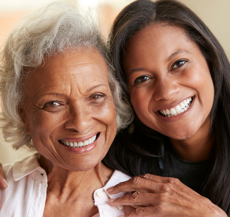 Black senior woman with black younger female volunteer