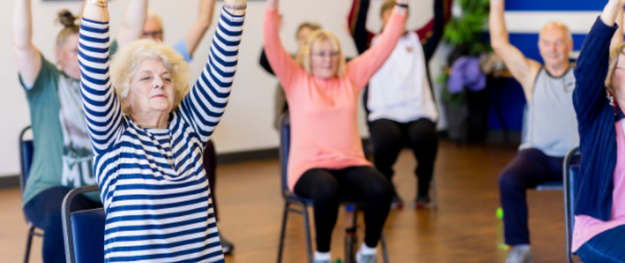 Group of seniors doing chair exercise class